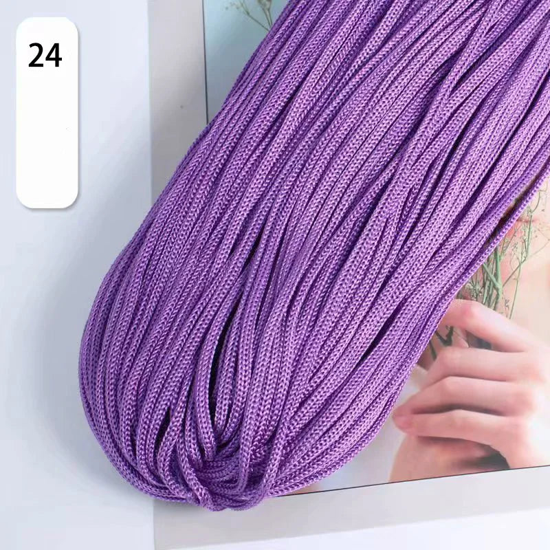 Purple braided cord with a blurred background